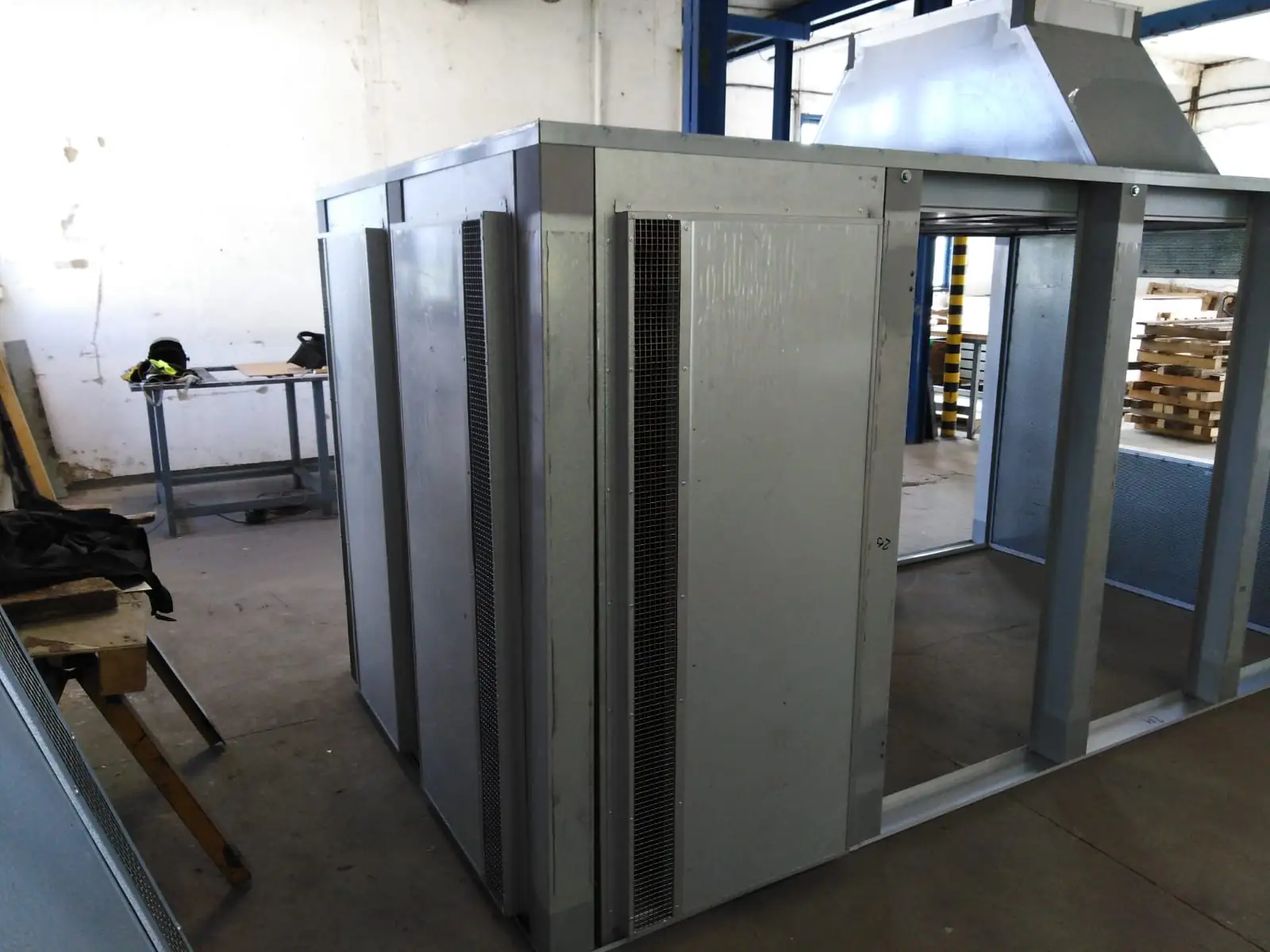 Interior view of a modular acoustic enclosure with metal panels and support structure
